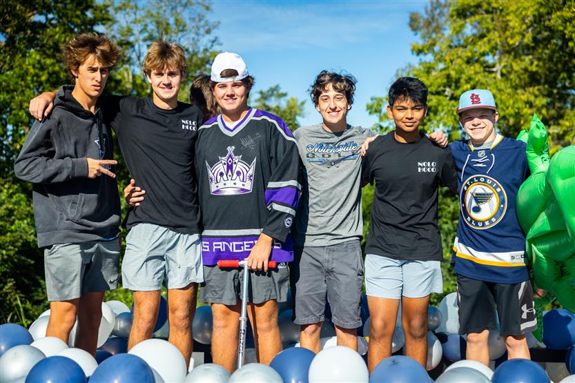 Students ride on a homecoming parade float
